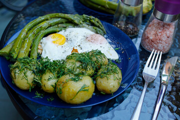 spring vegetarian meal: fresh asparagus with new young boiled potatoes with dill and fried egg