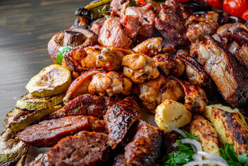 Assorted Mixed different grilled meat with vegetables on table