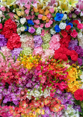 Colorful artificial flowers top view multicolor bouquet full frame, vertical picture, beautiful...
