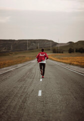 A man travels alone in the mountains on the road