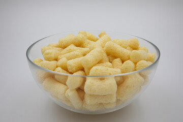 corn sticks in a transparent plate on a white background
