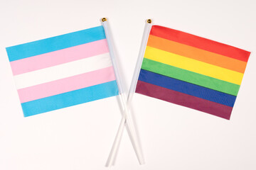 Fototapeta premium Small rainbow lgtb and trans flag over white background