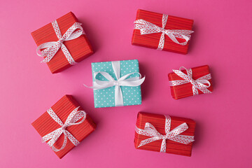 Blue and red gift boxes on pink background. Flat lay