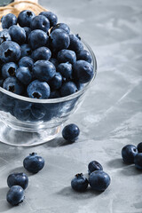 Blueberry gray background. Close-up, ripe blueberry berries on a gray background ecological packaging. Delivery of products, copies of space, photos for the catalog of stores.
