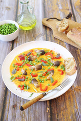 Omelet with green peas, red bell pepper and mushrooms