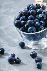 Blueberry gray background. Close-up, ripe blueberry berries on a gray background ecological packaging. Delivery of products, copies of space, photos for the catalog of stores.