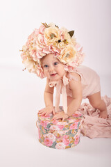 Sweet funny baby in hat with flowers. Easter greeting card, copyspace for your text. Poster for Easter holiday. Congratulations on Mother's Day. Cute baby girl. Children Protection Day
