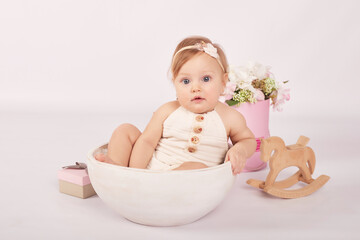 Sweet funny baby in hat with flowers. Easter greeting card, copyspace for your text. Poster for...