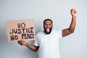 Stop racism. Photo of crazy dark skin african protester placard raise fist screaming rude slogans...