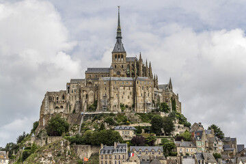 Obraz premium Abbey Mont Saint-Michel (VII century) at rocky tidal island in Normandy - one of most visited tourist sites in France. Normandy, Northern France, Europe.