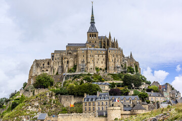 Abbey Mont Saint-Michel (VII century) at rocky tidal island in Normandy - one of most visited tourist sites in France. Normandy, Northern France, Europe.