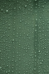 Fototapeta premium Raindrops on dark green metal surface