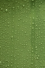 Raindrops on green metal surface
