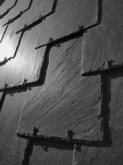 Close up on a slate shingled roof in monochrome
