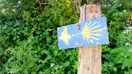 hande made sign pole in nature that indicates the route of ancient the Camino de Santiago