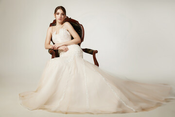 girl in a nude dress with tulle with lace on a white background