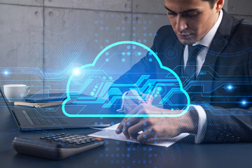A businessman in office taking notes using phone and storage cloud hologram. Multiexposure. Formal wear.