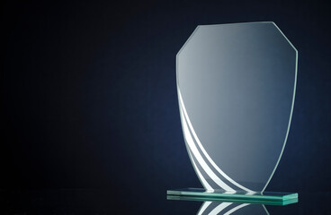 Elegant blank glass shield trophy on dark blue