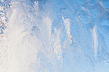 Frosted glass. Patterns made by the frost on the window. Winter background, ice on window. 