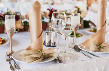 Beautiful decorated table set for wedding party. Old-fashioned wedding decorations with flowers. Rustic retro classical style