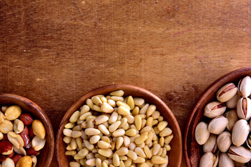 Mix of nuts in a wooden bowl