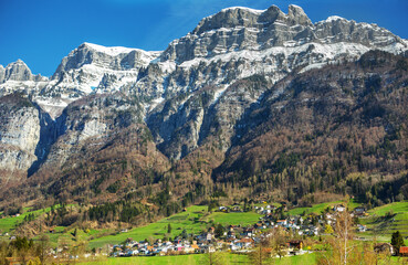 Swiss village in the valley next to the mountains in the St. Gallen canton, Switzerland.