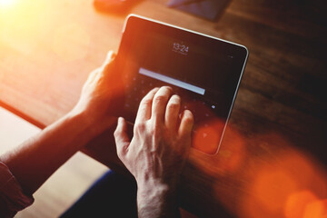  Young businessman using digital tablet for distance job during free recreation time