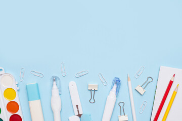 school Flat lay of stationery on blue background, copy space