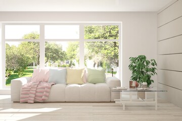 White stylish minimalist room with sofa and summer landscape in window. Scandinavian interior design. 3D illustration