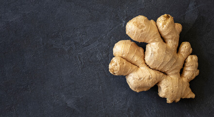 Fresh ginger root on dark background with copyspace, copy space, top view
