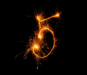 number five written with a sparkler on a black background