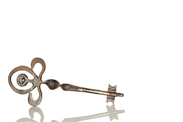 Single old metal key on white background with reflection, isolated on white background, copy space