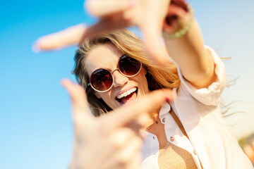 Happy young tourist smiling with sunglasses and camera