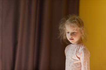  Portrait of a little girl at home. Disheveled little girl at home.