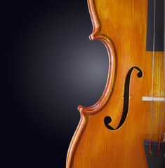 violin background. classical wooden musical instrument on dark backdrop