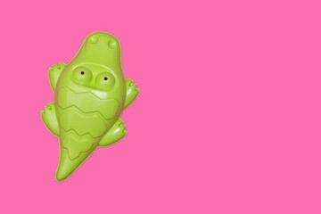 beach toy crocodile on pink background