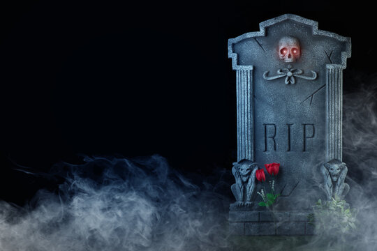 Grave with skull and flowers with RIP sign and fog on black background. It can be written on the grave. Ideal for Halloween
