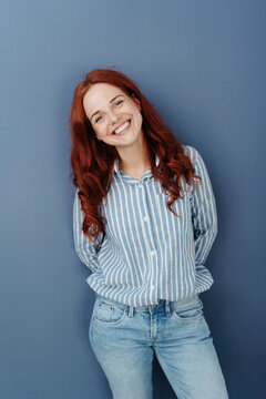 Cute red-haired smiling girl in striped shirt