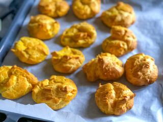 homemade eclairs in oven close-up. Sweet bakery. Dessert receipt. 