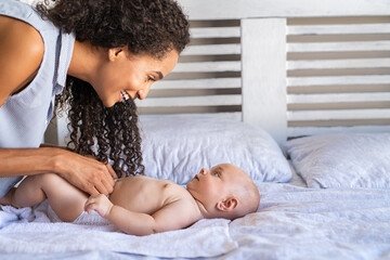 Mother changing baby diaper