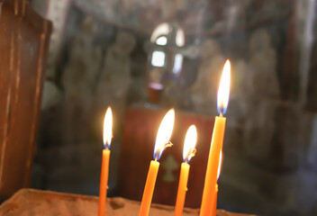 Burning candles in a dark Orthodox church. Rhodes. Greece.