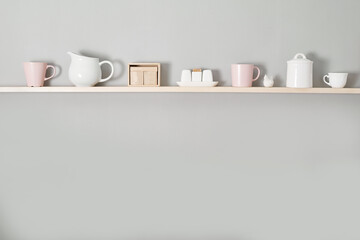 Kitchenware on wooden shelves. Kitchen interior background.Opened cupboard with kitchenware inside.