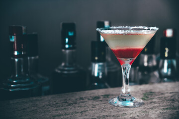 Glass of cocktail on bar background