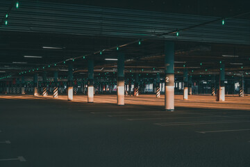 An empty covered  Parking lot with blue license plates lit up by the setting sun © KseniaJoyg