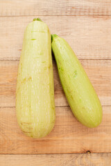 Large ripe and juicy zucchini on a wooden table. Healthy diet