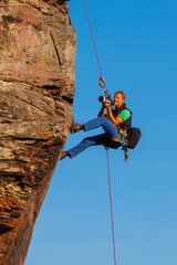 Photographer taking pictures in a rock wall