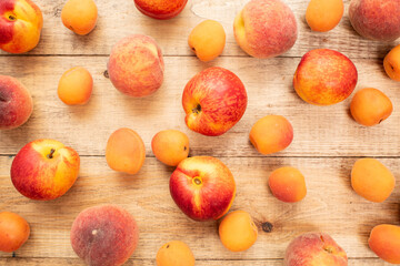 Large ripe and juicy peaches, apricots and nectarines on a wooden table. Healthy diet