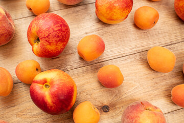 Large ripe and juicy peaches, apricots and nectarines on a wooden table. Healthy diet