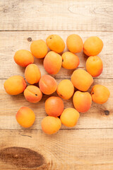 Large ripe and juicy apricots on a wooden table. Healthy diet