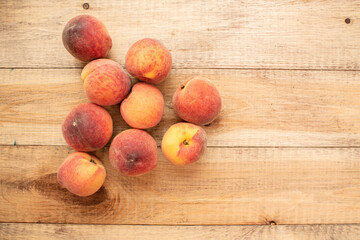 Large ripe and juicy peaches on a wooden table. Healthy diet
